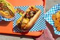 Image of Cheesesteaks on Blue and White Parchment Paper